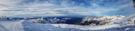 Panorama view from Mount Titlis showing skiers on a Swiss Alpine Slope